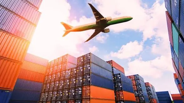 Cargo aircraft flying over a container terminal